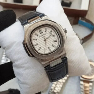 Luxury watch with black leather strap on a white cushion, brand name visible